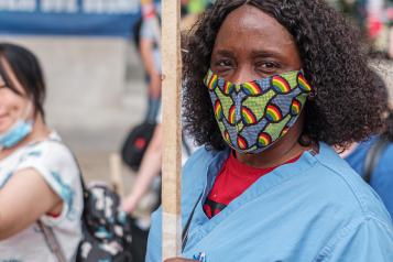  black female nurse with facemask at public demonstration.jpg